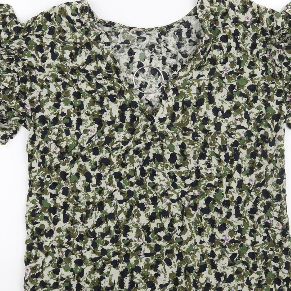 Brand and care label for Nutmeg women’s green floral basic t-shirt, size UK 8