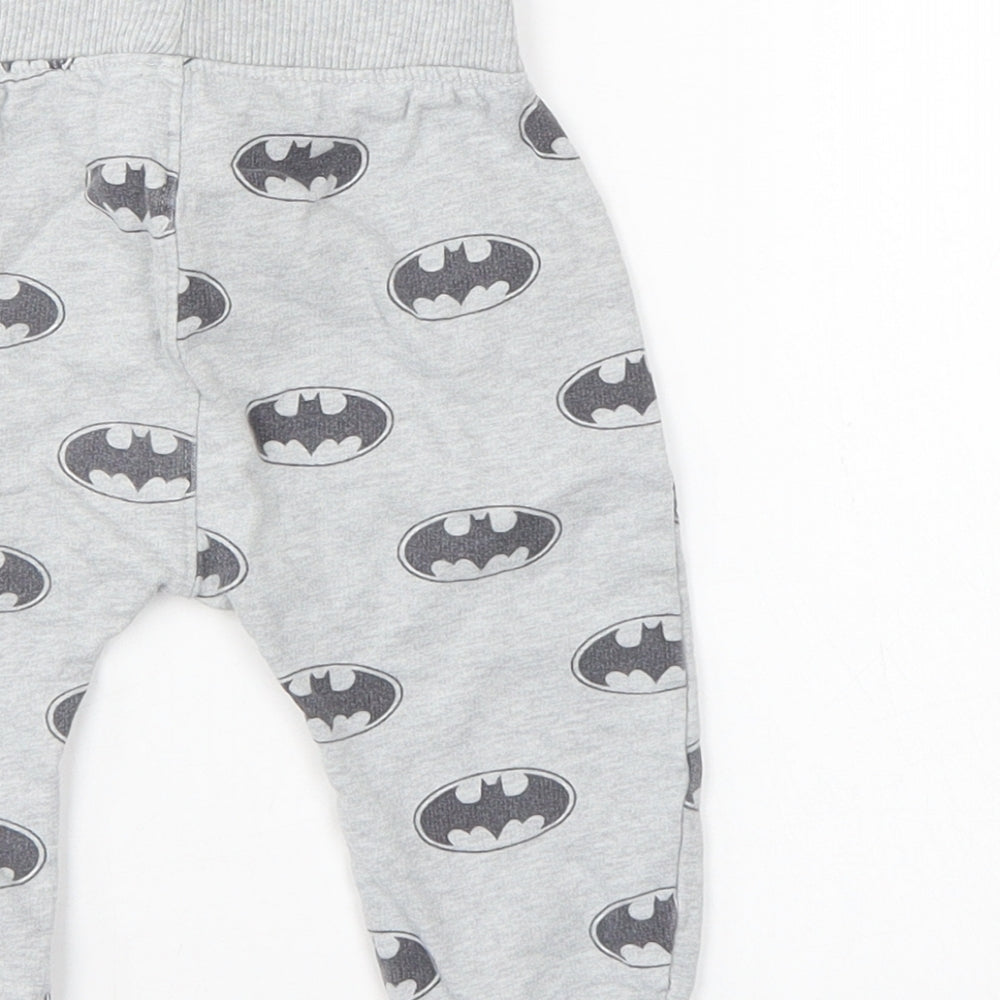 Brand and care label for Batman boys’ grey sweatpants, size 6-9, months
