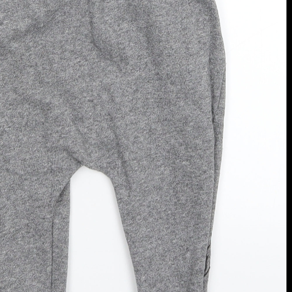 Brand and care label for Disney Baby Grey sweatpants, size 9-12, Months