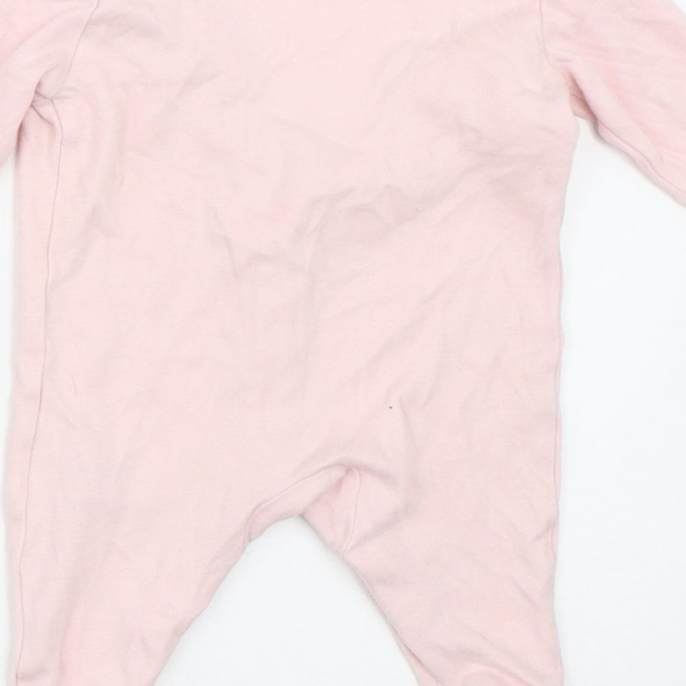 Brand and care label for Early Days girls’ pink babygrow one-piece size newborn