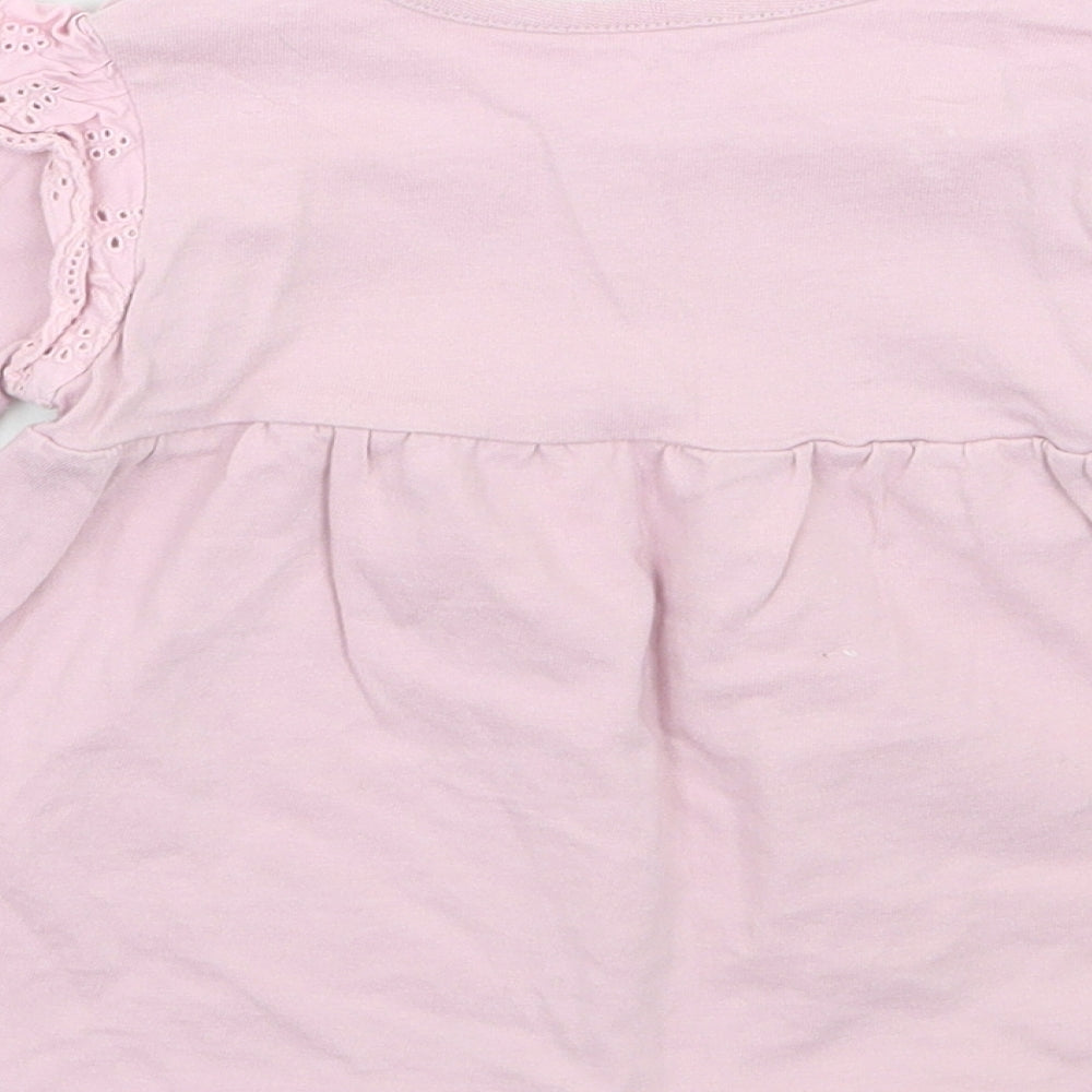 Brand and care label for Nutmeg girls’ purple basic t-shirt, size 12, months