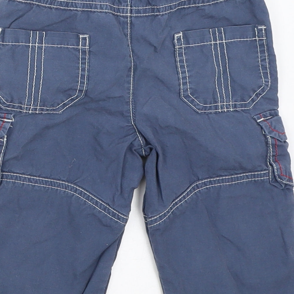 Brand and care label for Tu boys’ blue cargo trousers, size 6-9, months