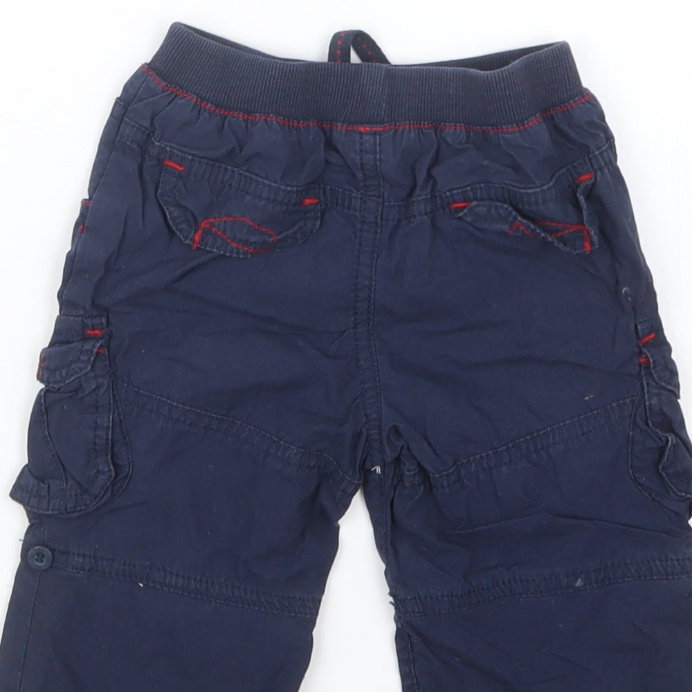Brand and care label for Tu boys’ blue cropped trousers, size 3-6, months