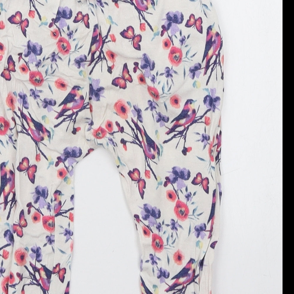 Brand and care label for dymples girls’ white floral jogger trousers, size 12, months