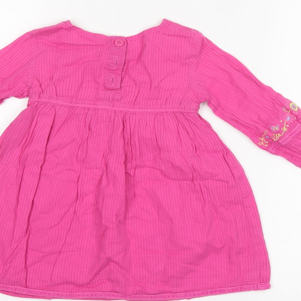 Brand and care label for Butterfly girls’ pink floral shift, size 12-18, months