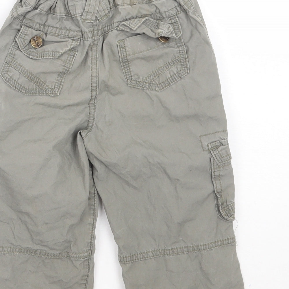 Brand and care label for Pumpkin Patch boys’ green cargo trousers, size 12-18, months