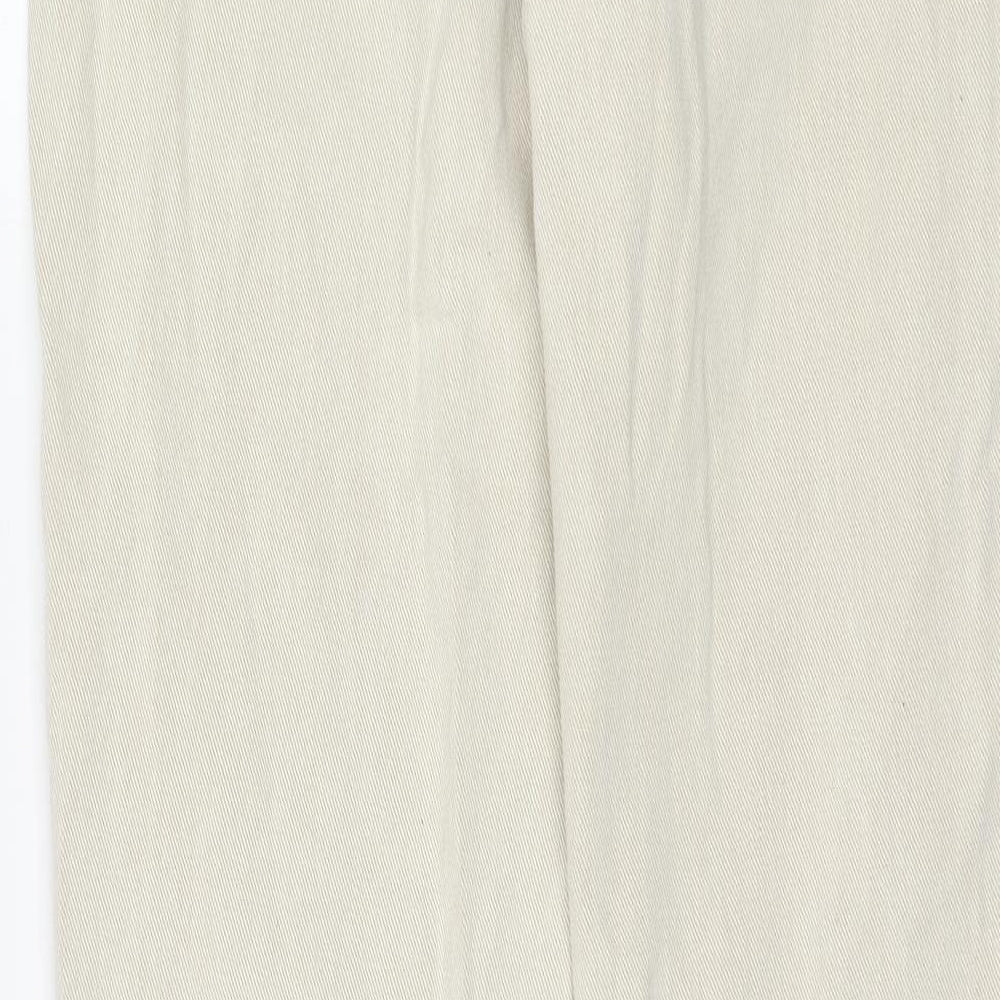 Brand and care label for Missguided women’s beige cotton mom jeans, size UK 12, regular zip