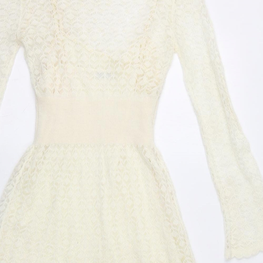 Brand and care label for Miss Selfridge women’s ivory acrylic fit & flare, size UK 10, boat neck pullover