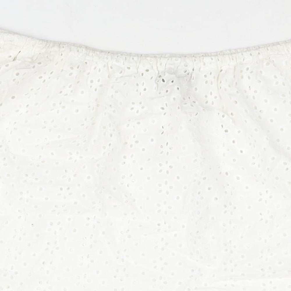 Brand and care label for ASOS women’s white cotton basic blouse, size UK 10, off the shoulder