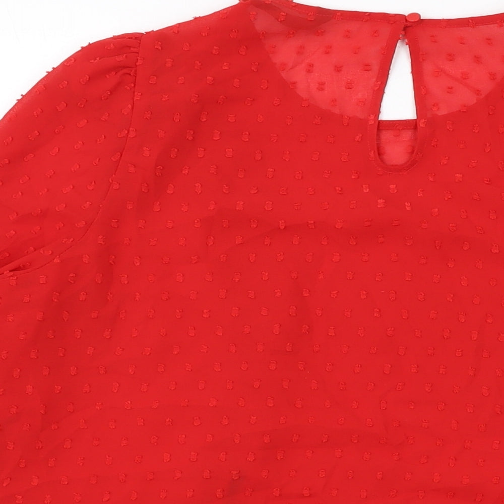 Brand and care label for Dunnes women’s red polyester basic blouse, size L, round neck