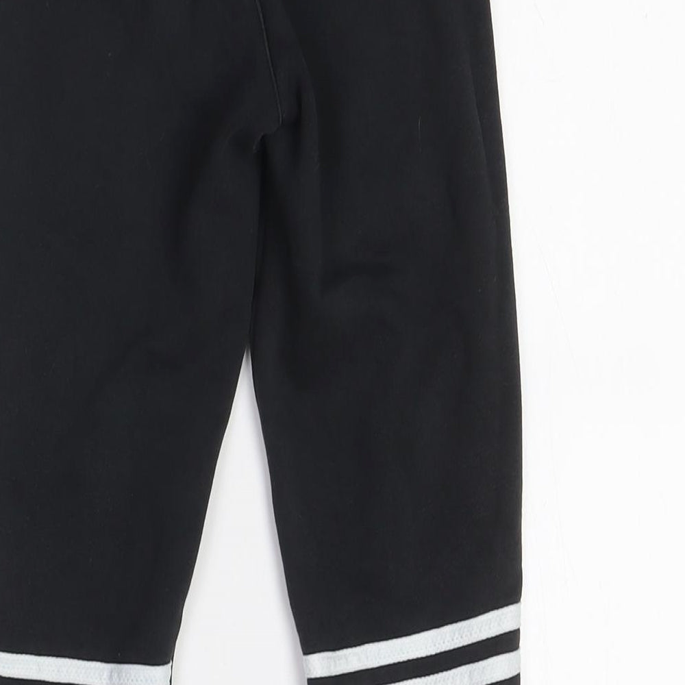 Brand and care label for Adidas boys’ black jogger trousers with side stripe