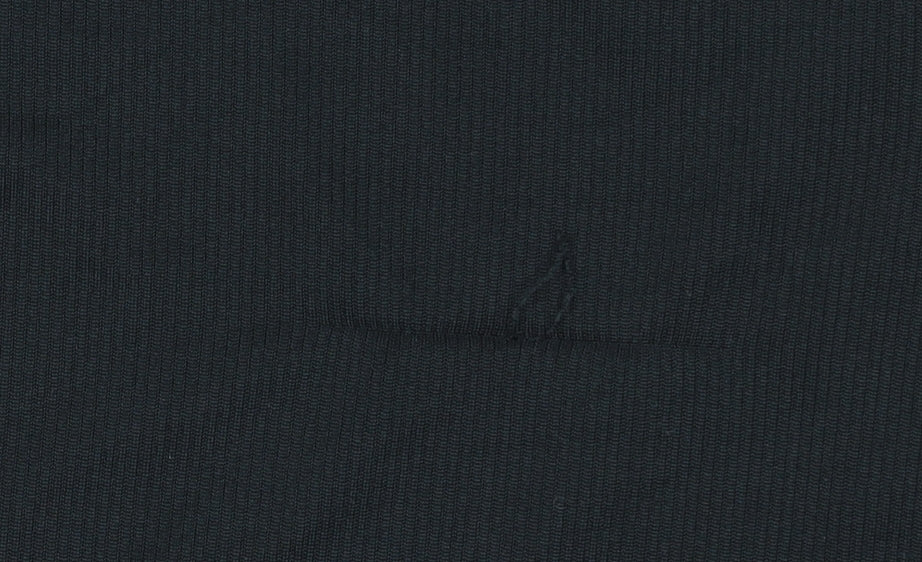 Brand and care label for Sondico boys’ black athletic shorts 13 years