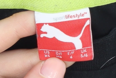 Close-up detail of Puma boys’ black graphic t-shirt 5-6 years, logo accent