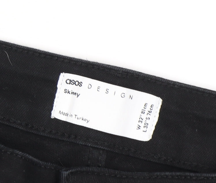 Close-up detail of ASOS men’s black skinny jeans, size 32, regular