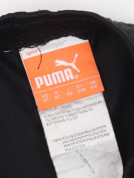 Close-up detail of Puma boys’ black active shorts, size 12-18, months