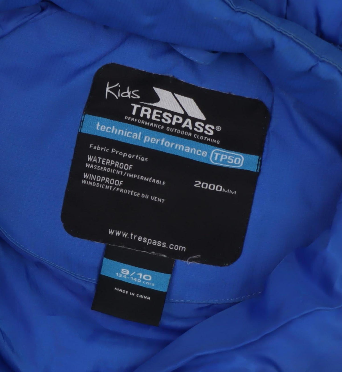 Close-up detail of Trespass boys’ blue puffer jacket waterproof 9-10 years