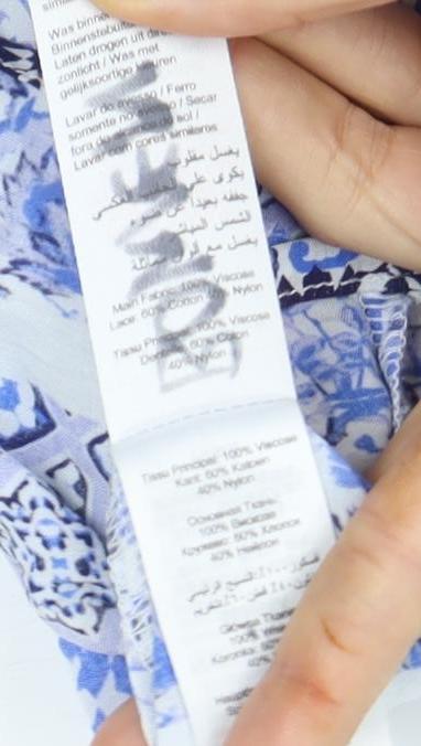 Brand and care label for Roman Women's Blue Geometric Tunic Open Front Blouse, size M
