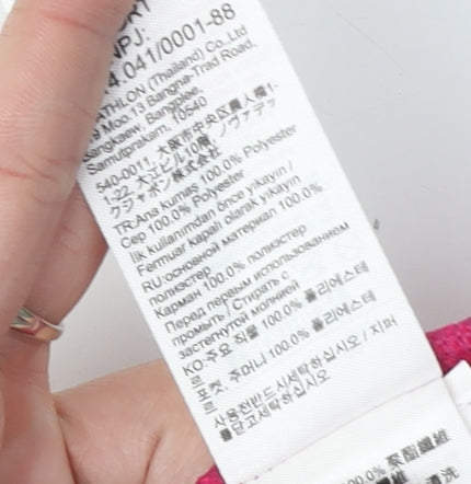 Brand and care label for Decathlon girls’ pink track jacket, 14 years