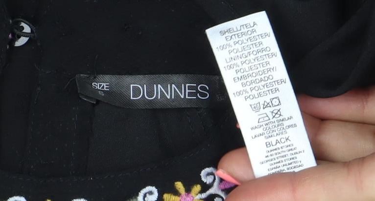 Brand and care label for Dunnes women’s black embroidered chiffon bohemian blouse m