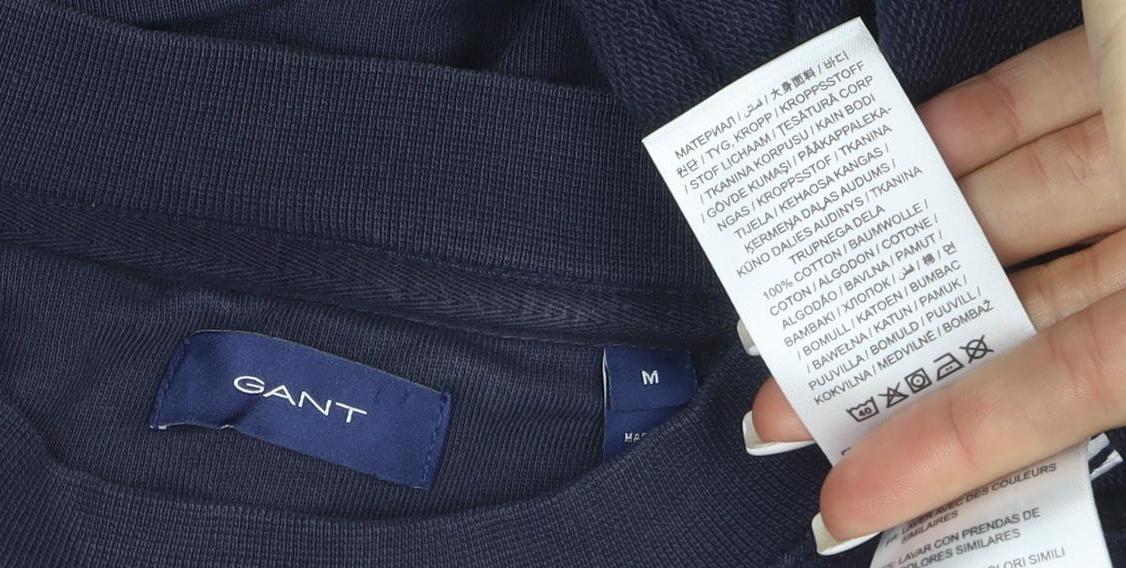Brand and care label for GANT women’s navy blue cotton crew neck pullover sweatshirt, size M