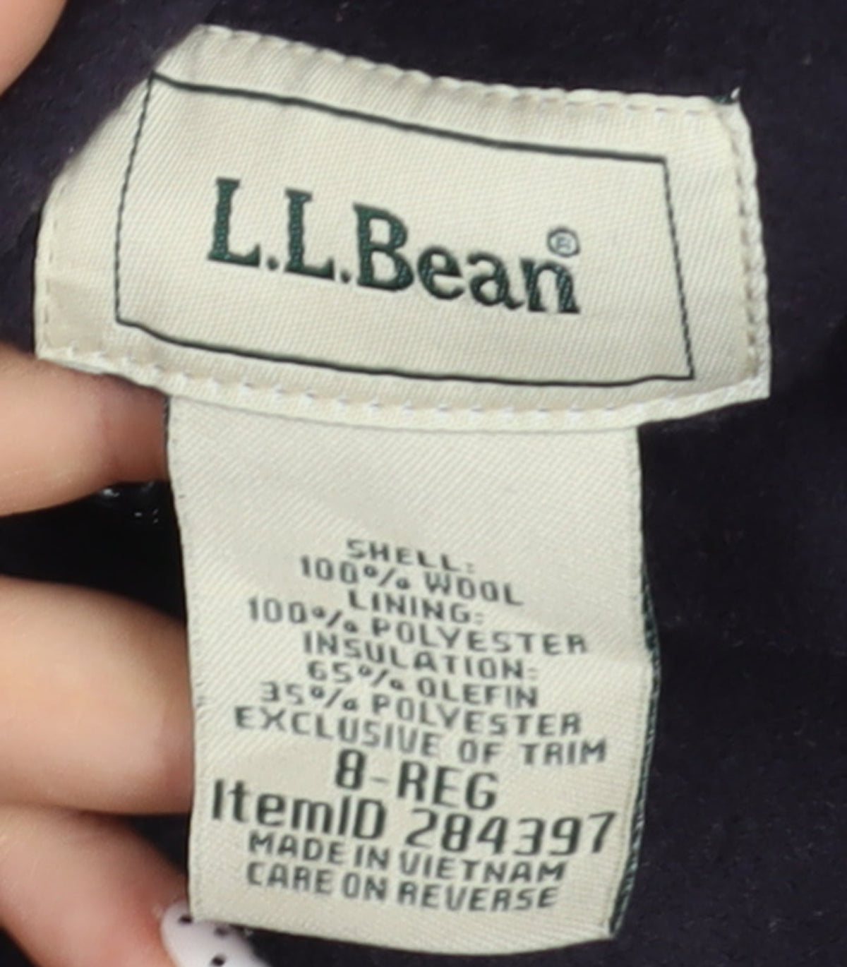 Brand and care label for L.L. Bean Women's Black Wool Duffle Coat, size 8, Hooded Mid-Length