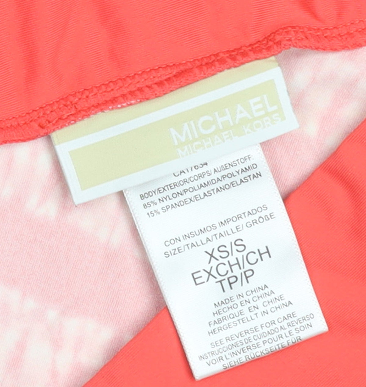 Brand and care label for Michael Kors women’s pink striped beach cover up xs