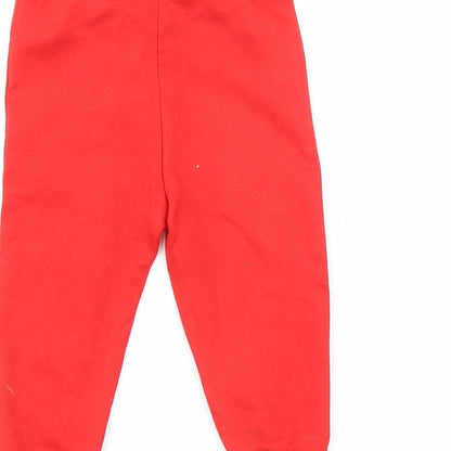 Brand and care label for Disney boys’ red jogger trousers, size 9, months