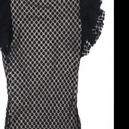 Close-up detail of TFNC women’s black polka dot mini, size L, - open back
