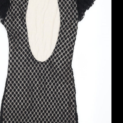 Brand and care label for TFNC women’s black polka dot mini, size L, - open back