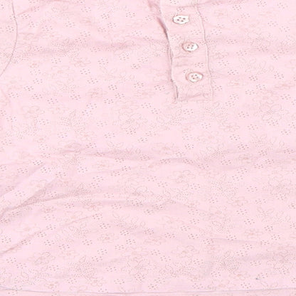 Brand and care label for Mothercare girls’ pink basic blouse, size 9-12, months