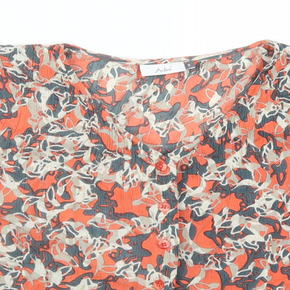 Close-up detail of Adini women’s orange geometric basic button-up, size S