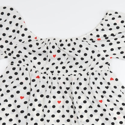 Close-up detail of Wednesday's girl women’s white polka dot shift, size L