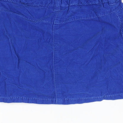 Brand and care label for Next girls’ blue mini skirt, size 7, years