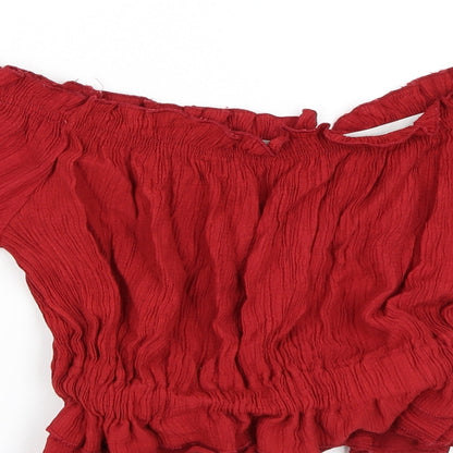 Close-up detail of Preworn women’s red cropped blouse, size S