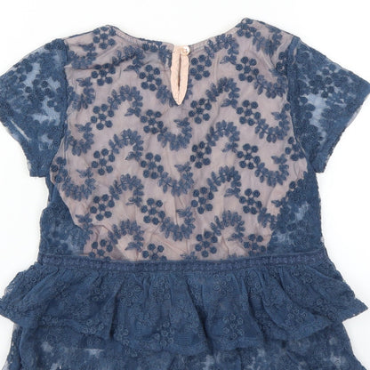 Brand and care label for Next girls’ blue floral basic blouse, size 7, years - embroidered floral layer