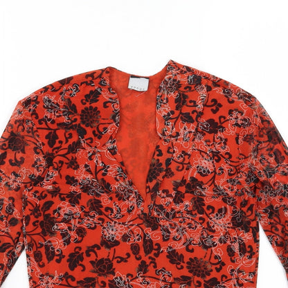 Close-up detail of Preworn women’s orange floral basic blouse, size UK 10