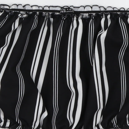 Brand and care label for New Look girls’ black striped basic blouse, size 12, years