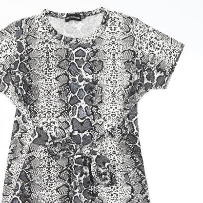 Close-up detail of PRETTYLITTLETHING women’s white animal print mini, size UK 8