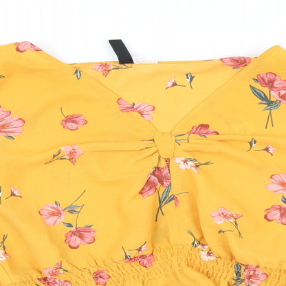 Close-up detail of H&M women’s yellow geometric basic blouse, size UK 8
