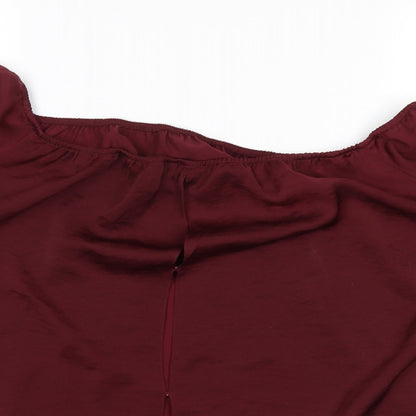Close-up detail of River Island women’s red basic blouse, size UK 12