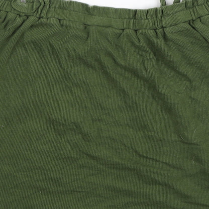 Brand and care label for Primark girls’ green basic tank, size 10, years