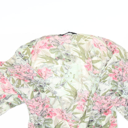 Close-up detail of Preworn women’s green floral basic blouse, size S