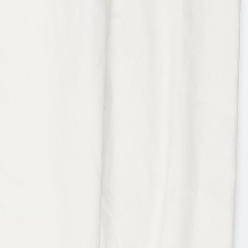 Brand and care label for Candy Couture girls’ white denim skinny jeans, size 13, years