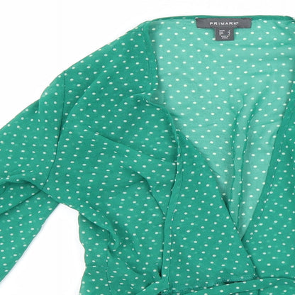 Close-up detail of Primark women’s green polka dot basic blouse, size UK 6