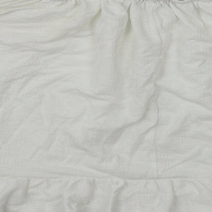 Brand and care label for Atmosphere women’s white cropped blouse, size UK 4