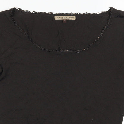 Close-up detail of proportion women’s black basic blouse, size S