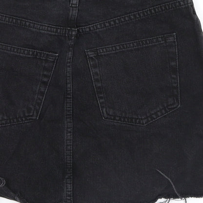 Brand and care label for Topshop women’s black denim mini skirt, size UK 6