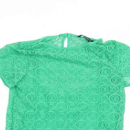 Close-up detail of Dunnes women’s green geometric basic blouse, size UK 10