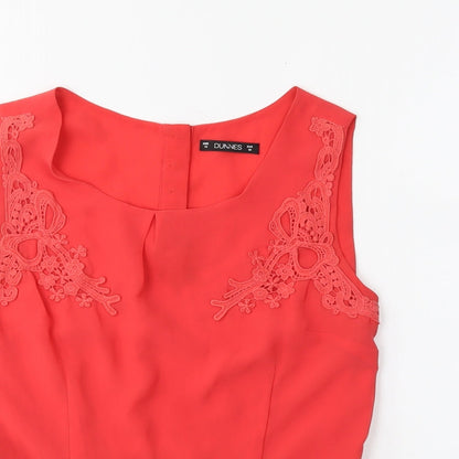 Close-up detail of Dunnes women’s orange basic blouse, size UK 10