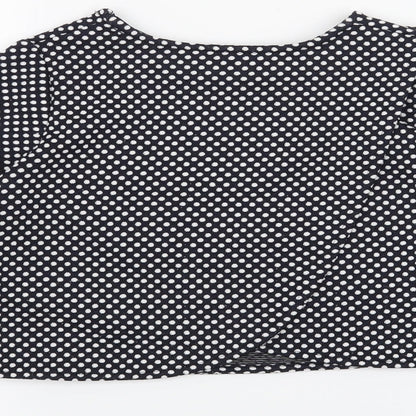 Brand and care label for St Bernard girls’ blue polka dot basic t-shirt, size 9, years